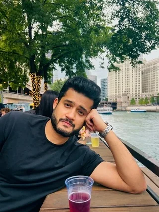 Prateek sitting beside the Chicago riverwalk.